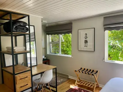 a room with a desk and two windows at Stellenbosch Serenity in Stellenbosch
