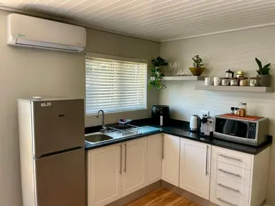 a kitchen with a refrigerator and a microwave at Stellenbosch Serenity in Stellenbosch