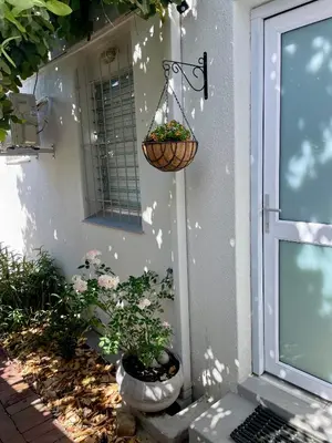 a porch with two potted plants on the side of a house at Stellenbosch Serenity in Stellenbosch