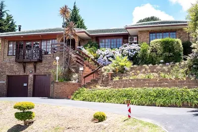 a brick house with a staircase in front of it at MJ's Guest House in Cape Town