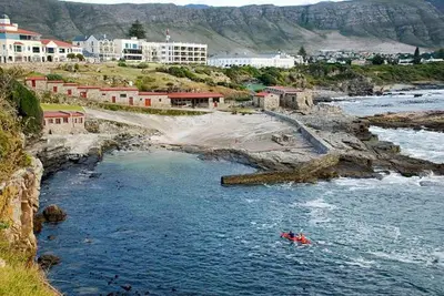 a group of people in a boat in a river at Ocean Breeze @ Hermanus Beach Club in Hermanus