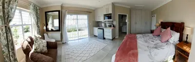 a bedroom with a bed and a living room at 22's Company in Cape Town