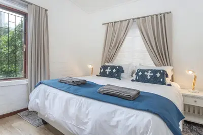 a bedroom with a bed with two pillows on it at The Atlantic in Onrus in Hermanus