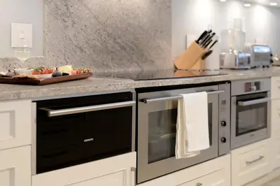 a kitchen with a black oven and a counter at Farm Lorraine Lake Cottage, Loft Cottage and Garden Cottage in Franschhoek