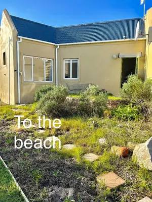 a house with the words to the beach in front of it at The Annex in Pringle Bay