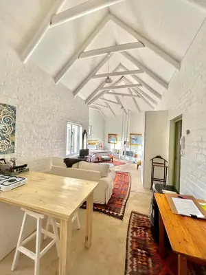 a living room with a table and a couch at The Annex in Pringle Bay