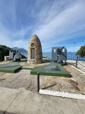 a monument in front of the ocean with a clock at *Self-Check in - Whale Watching Paradise -Central* in Hermanus