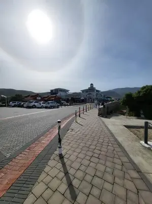 a cobblestone street with parking meters on it at *Self-Check in - Whale Watching Paradise -Central* in Hermanus