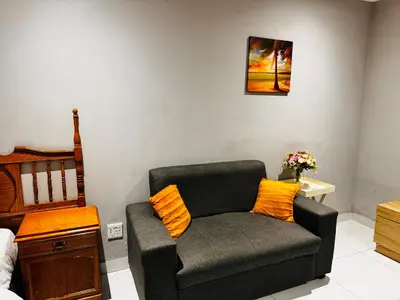 a living room with a couch and a chair at Mila Lodge 1 in Cape Town