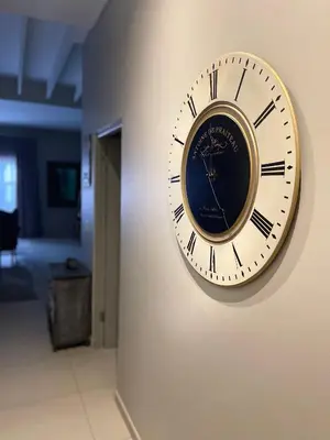 a clock hanging on a wall in a hallway at Meerendahl Luxury Apartments at Heritage Square in Durbanville