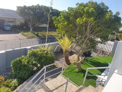 a view from the balcony of a yard with trees at Gardenia Guesthouse in Cape Town