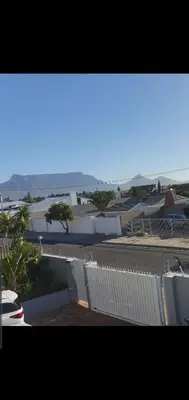 a view of a city with a white fence at Gardenia Guesthouse in Cape Town