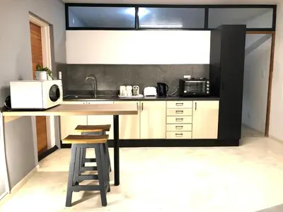 a kitchen with a counter with a microwave and a sink at Paarl Views in Paarl