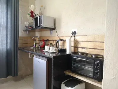 a kitchen with a counter top with a microwave at Coastal Cozy 1 in Cape Town