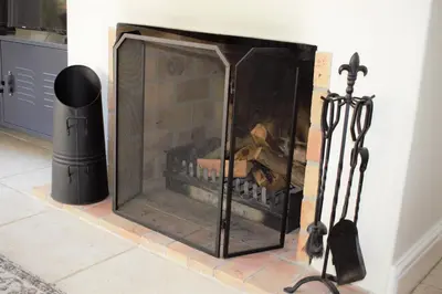 a fireplace in a living room with a black at Le Habitat 6 in Franschhoek