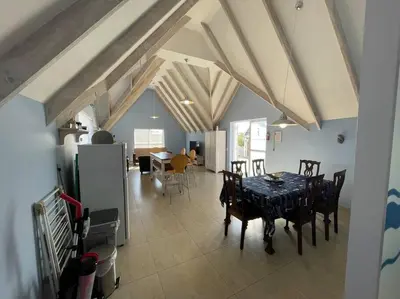 a kitchen and dining room with a table and chairs at De Blauwvoet - Meerkat (Sunset Beach) in Cape Town