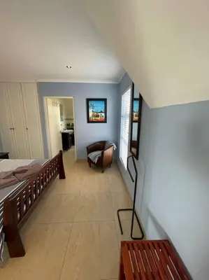 a bedroom with a bed and a couch in a room at De Blauwvoet - Meerkat (Sunset Beach) in Cape Town