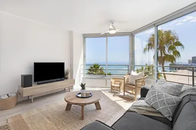 a living room with a couch and a tv at Welgelegen 608 in Strand