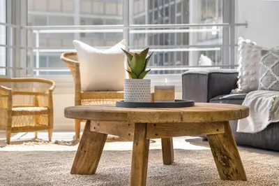 a living room with a wooden coffee table with a plant on it at Welgelegen 608 in Strand