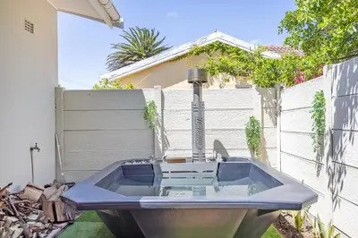 a bath tub in the backyard of a house at Blouberg Studio Apartments in Bloubergstrand
