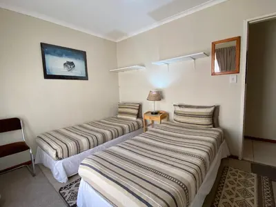 a hotel room with two beds in a room at Blouberg Cosy 2 bedroom house in Cape Town