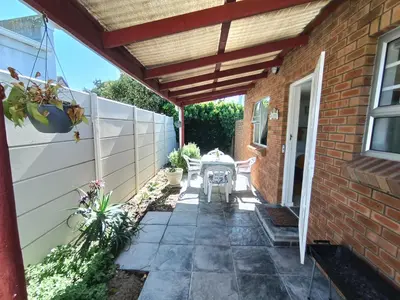 a patio with awning and a brick house at NoulAnouk's Corner - Peaceful Studio in Cape Town