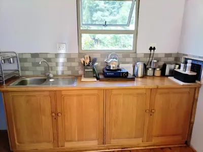 a kitchen counter with a sink and a window at Glamping at The Well in Franschhoek in Franschhoek