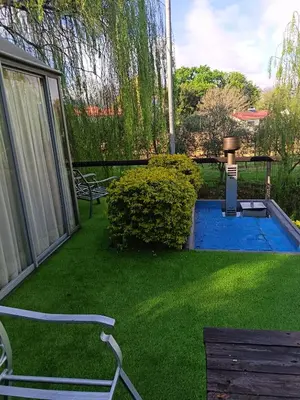 a backyard with a swimming pool and green grass at Glamping at The Well in Franschhoek in Franschhoek