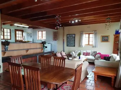 a living room with a table and a couch at Witteklip self-catering farm in Kleinmond