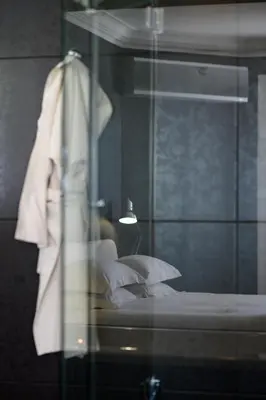 a glass window of a bedroom with a bed at Fijnbos Private Manor in Gordonʼs Bay