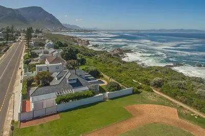 an aerial view of a house with the ocean at Wild Waters at Kraal Rock on the cliffs in Hermanus in Hermanus