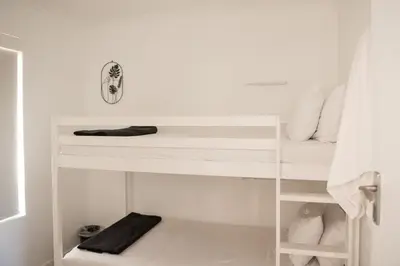 a white bunk bed in a white room at Hermanus Sea Breeze in Hermanus