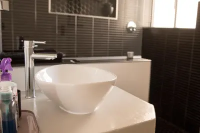 a white bowl sitting on top of a bathroom counter at Hermanus Sea Breeze in Hermanus