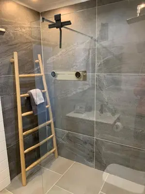 a bathroom with a shower with a glass door at Maîté Iphupho in Somerset West
