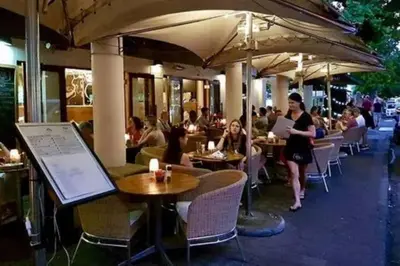 a group of people sitting at tables in a restaurant at The Lookout Loft, a short stroll into town in Stellenbosch