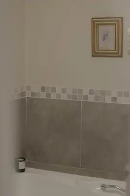 a bathroom with a sink and a picture on the wall at Three Streams Cottages in Franschhoek
