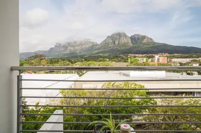 a view from a balcony with mountains in the background at The Rondebosch on Belmont in Cape Town