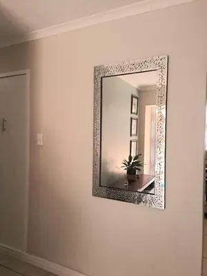 a mirror on a wall in a room at Cosy and Central Family Home in Cape Town
