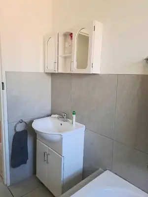 a bathroom with a sink and a toilet at Cosy and Central Family Home in Cape Town