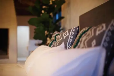 a close up of a bed with pillows on it at Tollbosch in Somerset West