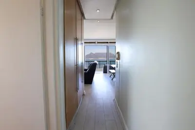 a hallway with a door and a room with a view at Portico 1006 Beachfront Apartment with Panoramic Views in Cape Town