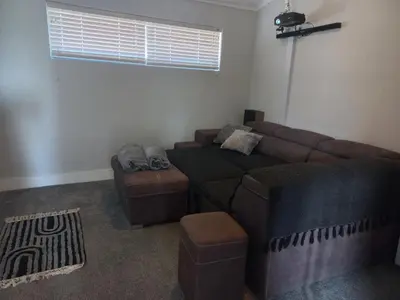 a living room with a couch and a couch and chair at Kwikstertjie in Hermanus