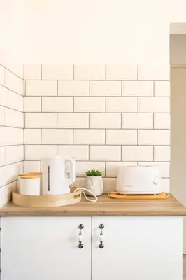 a counter top with a toaster and appliances on it at Innie Baai Beach House in Cape Town
