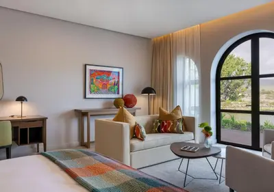 a living room with a bed and a couch at The Hazendal Hotel and Spa in Stellenbosch