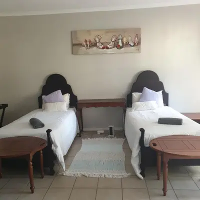two beds sitting next to each other in a room at Irma's farmstay at the Nuy Valley Guesthouse in Nuy
