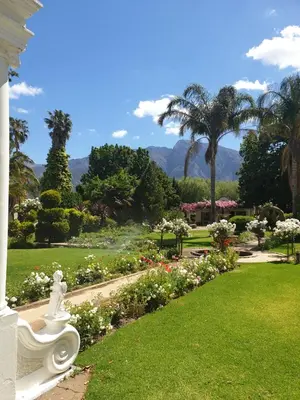 a garden with a white statue in the grass at Irma's farmstay at the Nuy Valley Guesthouse in Nuy