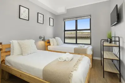 a bedroom with two beds and a window at Cape on Porterfield 5 in Bloubergstrand