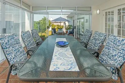 a table with chairs and a bowl on top at 3-Bed-Mountain View in Hermanus