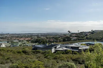an aerial view of a city with houses and a river at Boskloof Eco House I in Somerset West