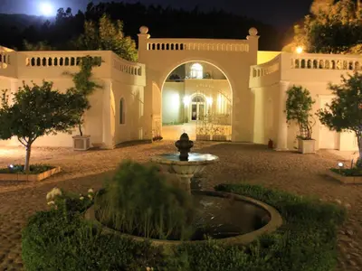 a fountain in the middle of a courtyard at night at Retreat at Waterfall Valley in Paarl